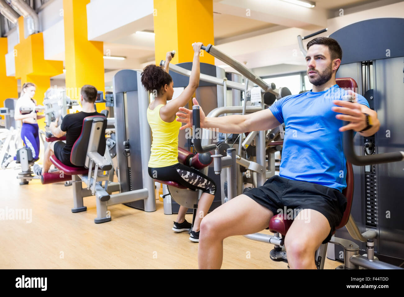 Fit people using weights machines Stock Photo Alamy