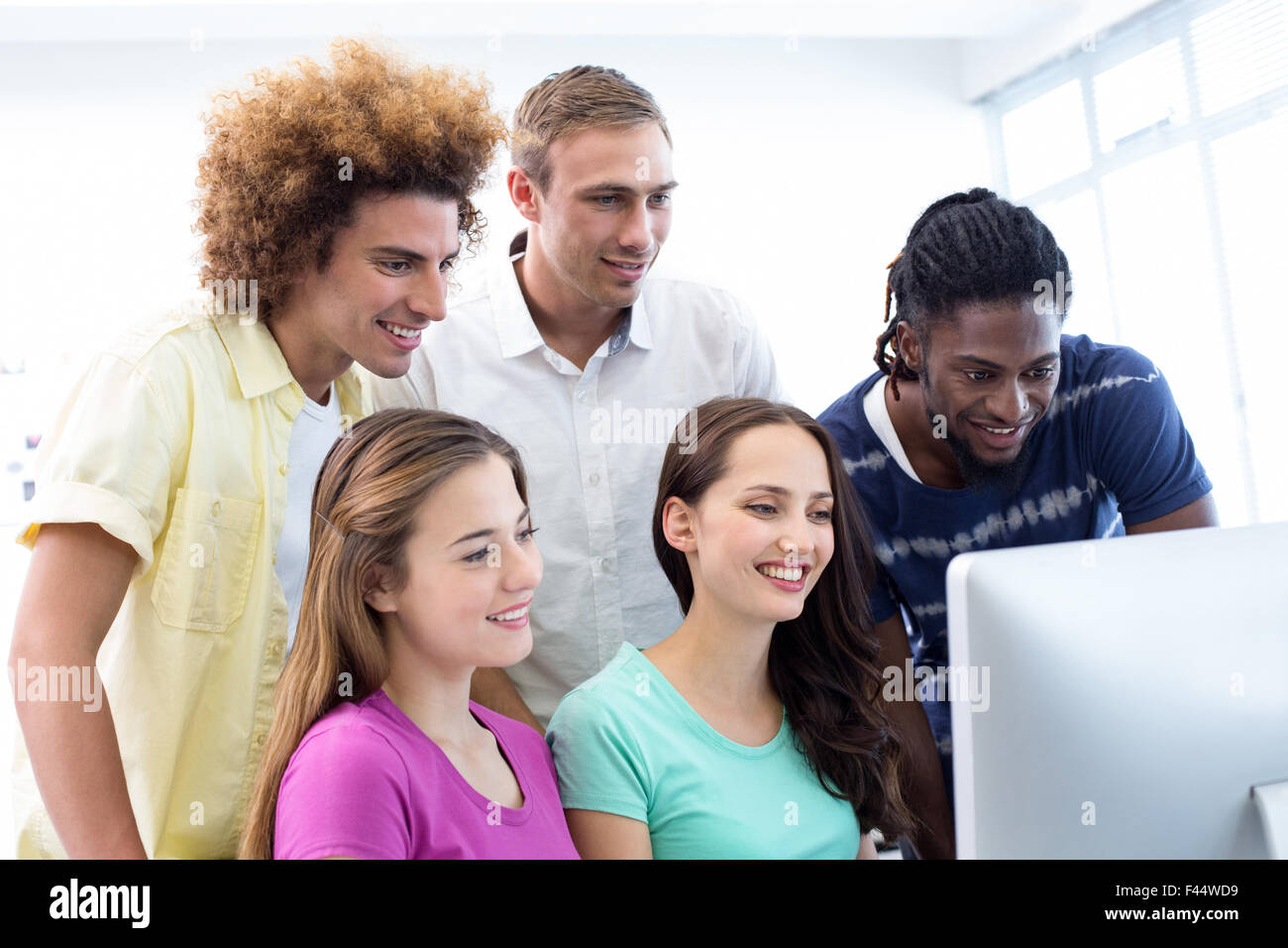Smiling students in computer class Stock Photo - Alamy