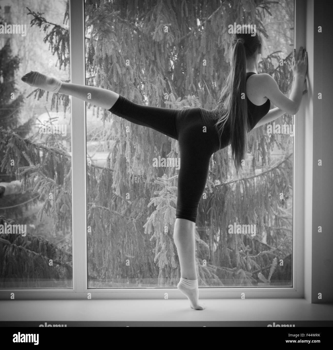 Young dancing girl on window Stock Photo