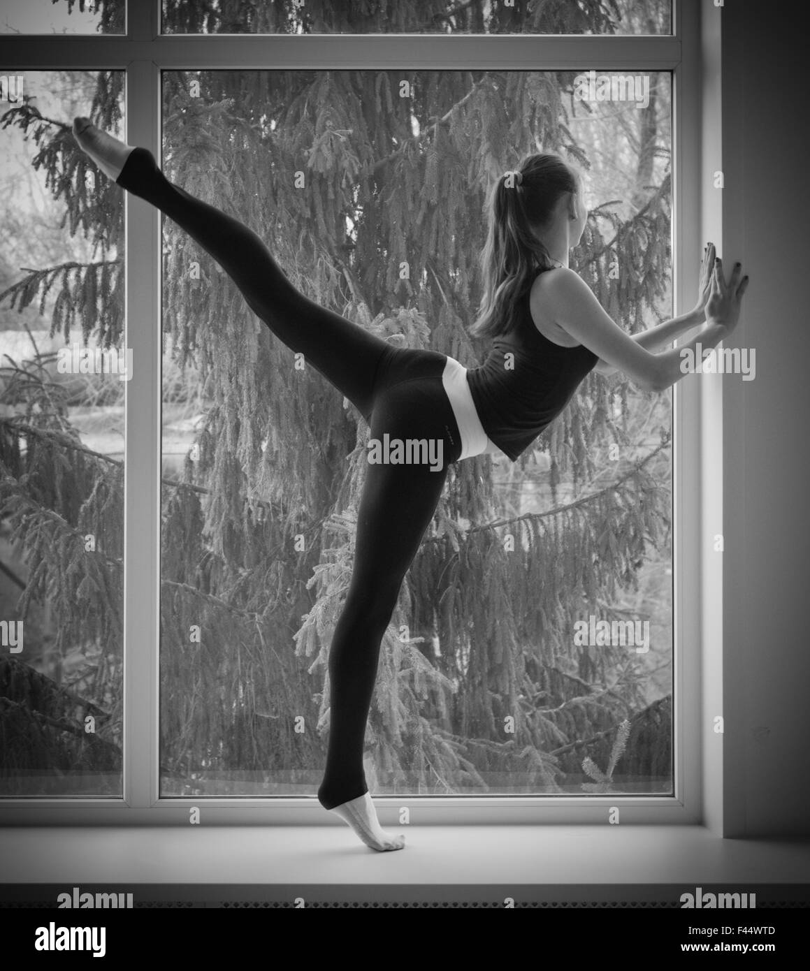 Young dancing girl on window Stock Photo