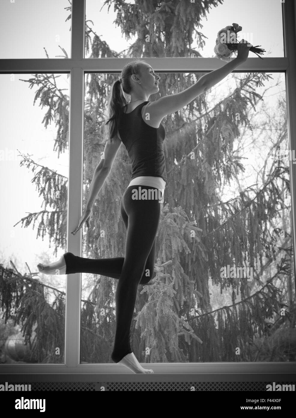 Young dancing girl on window Stock Photo