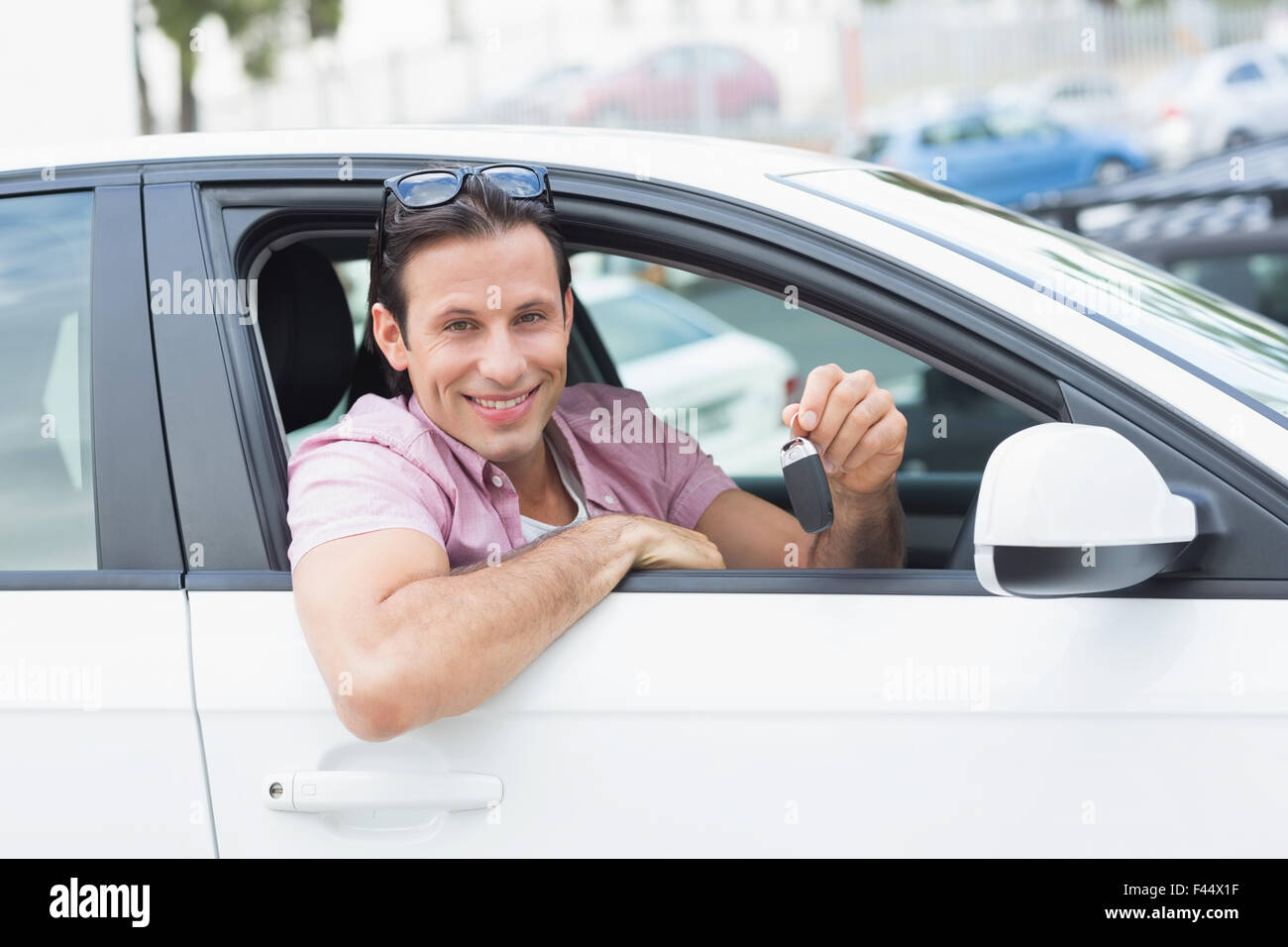 Man smiling and showing key Stock Photo - Alamy