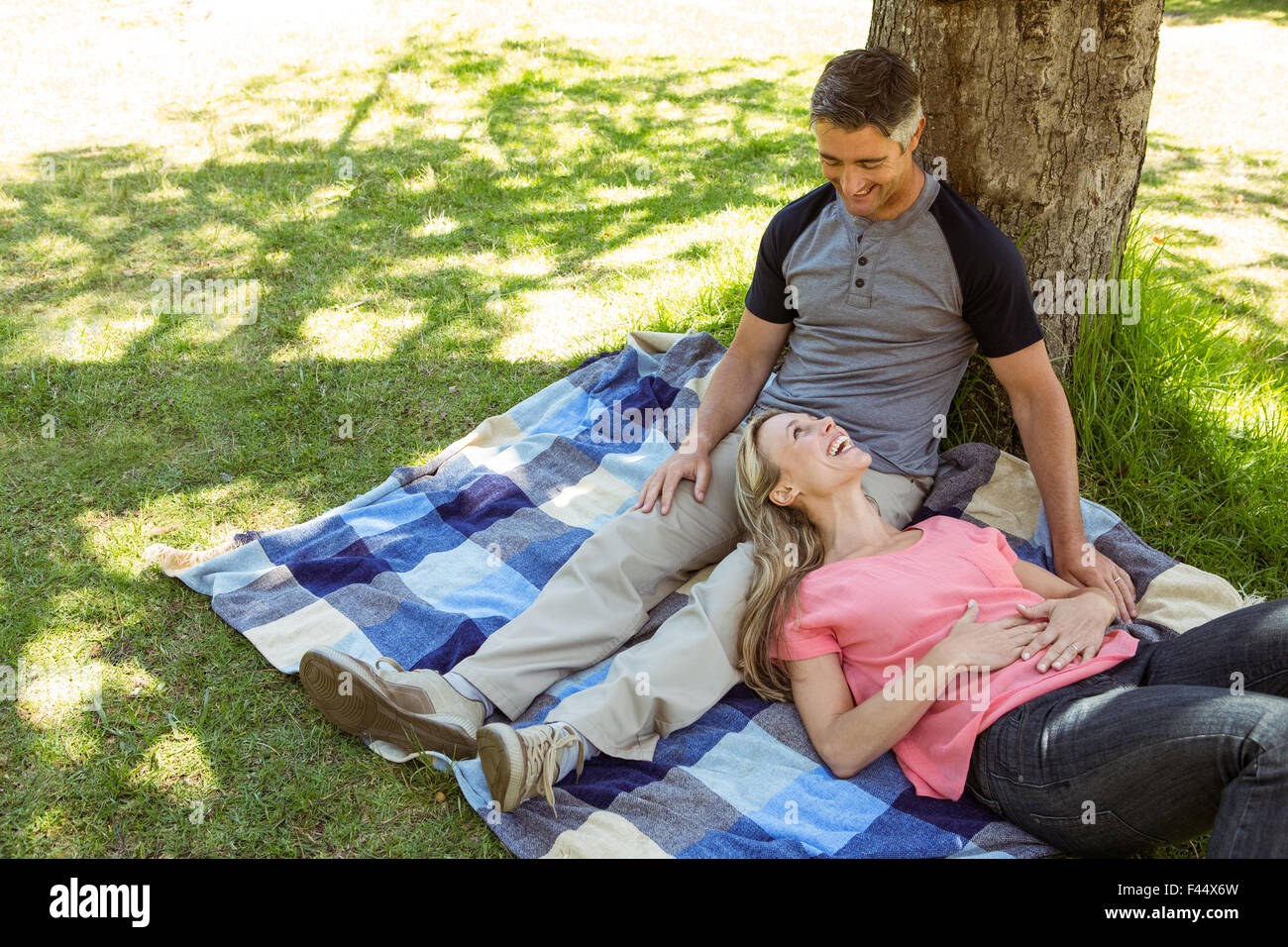 Happy couple relaxing in the park Stock Photo - Alamy