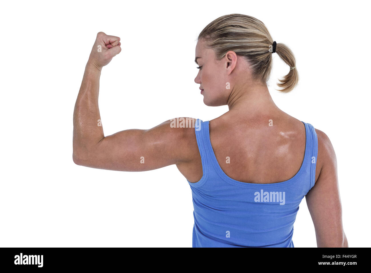 Rear view of muscular woman flexing muscles Stock Photo