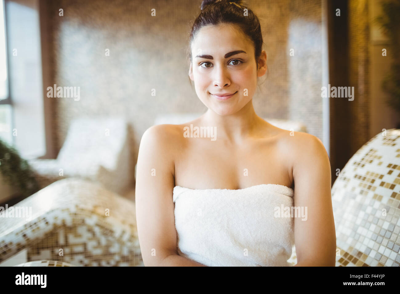 Woman sitting down wearing a towel Stock Photo
