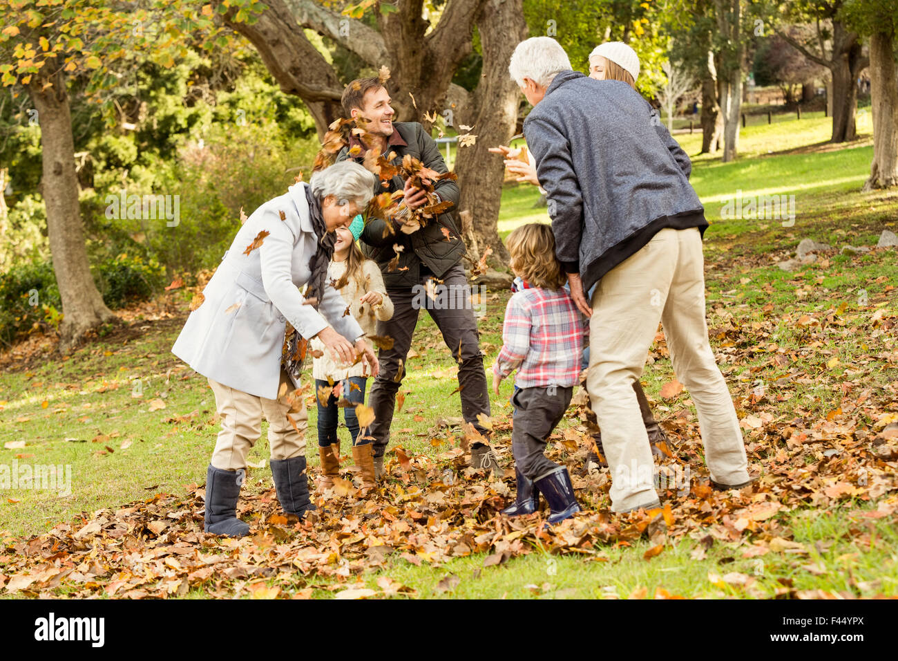 Happy family playing in the park together Stock Photo