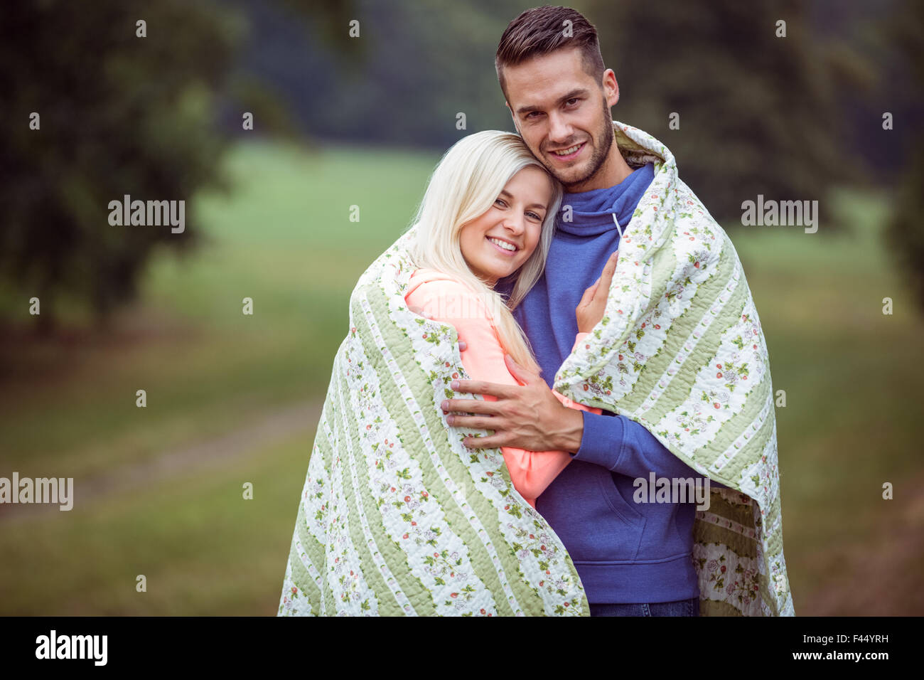 Couple hugging under blanket hi res stock photography and images