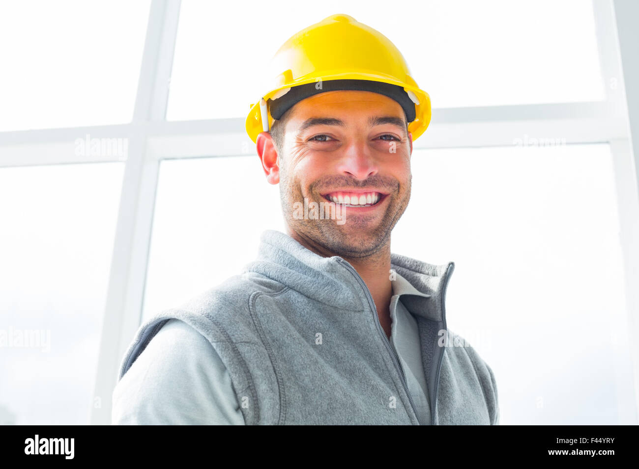 Manual worker wearing hardhat in building Stock Photo