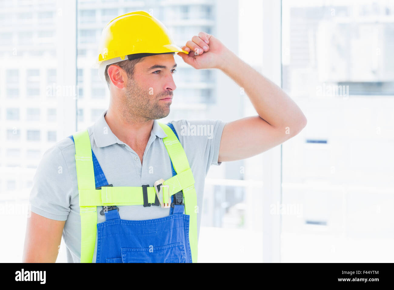 Manual worker wearing yellow hard hat Stock Photo