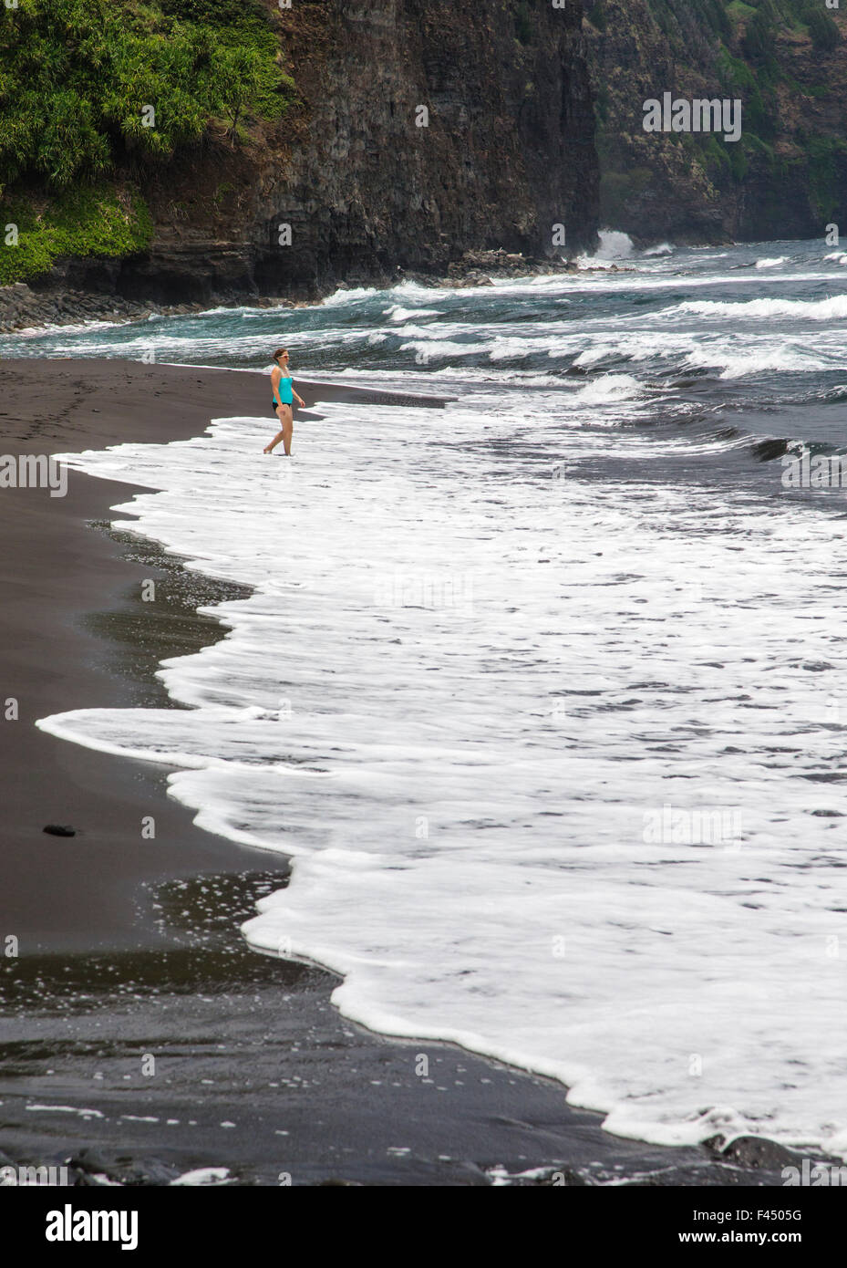 Visitor on beach at Akoakoa Point, Polulu Valley, Big Island of Hawai’i, Hawai’i, USA Stock Photo