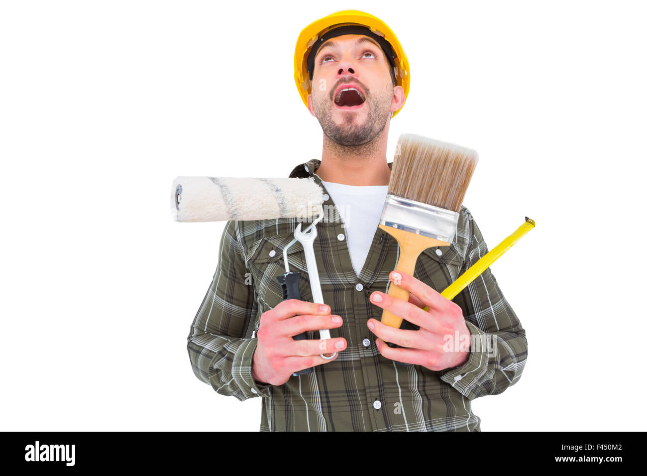 Screaming manual worker holding various tools Stock Photo