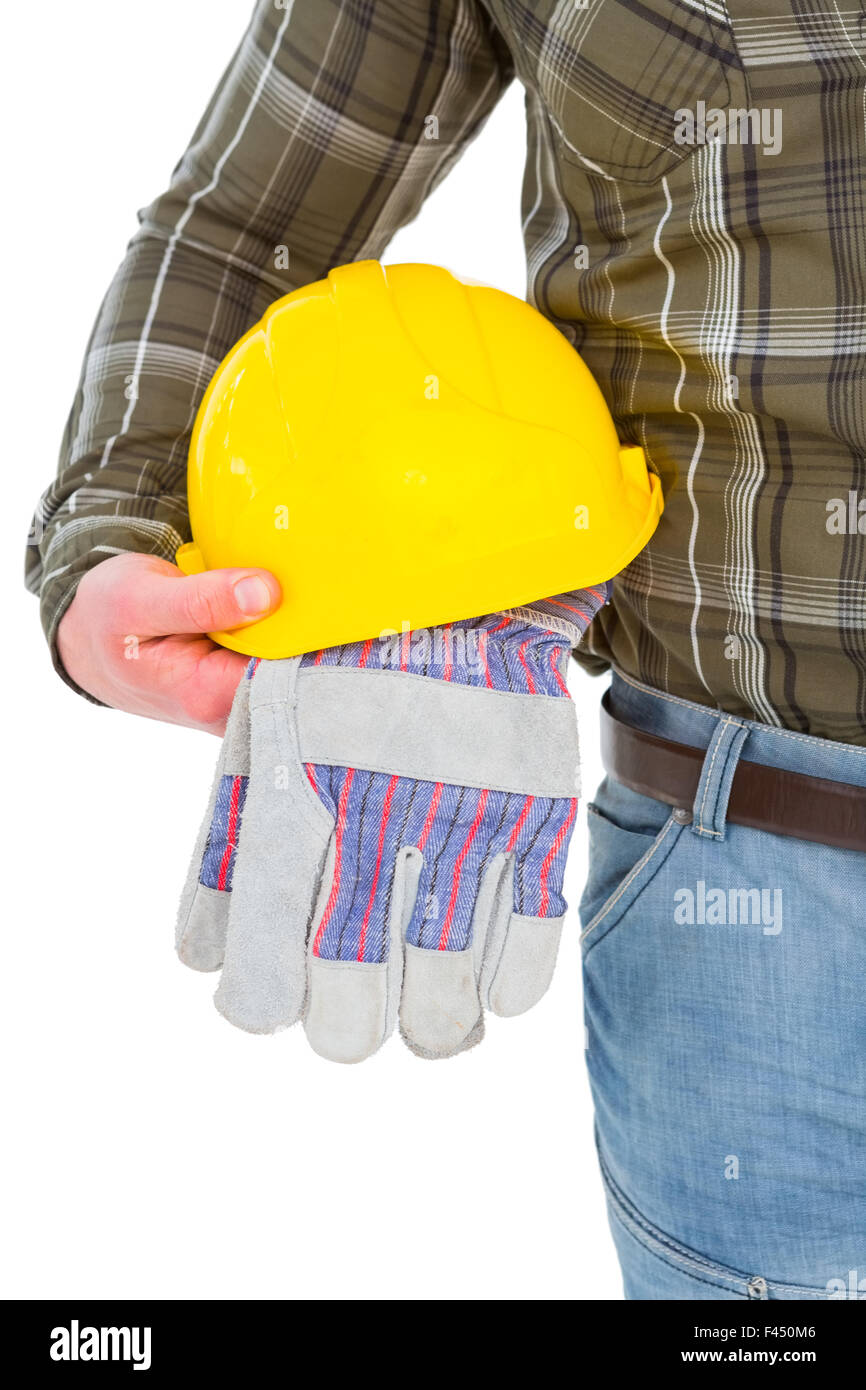 Manual worker holding helmet and gloves Stock Photo