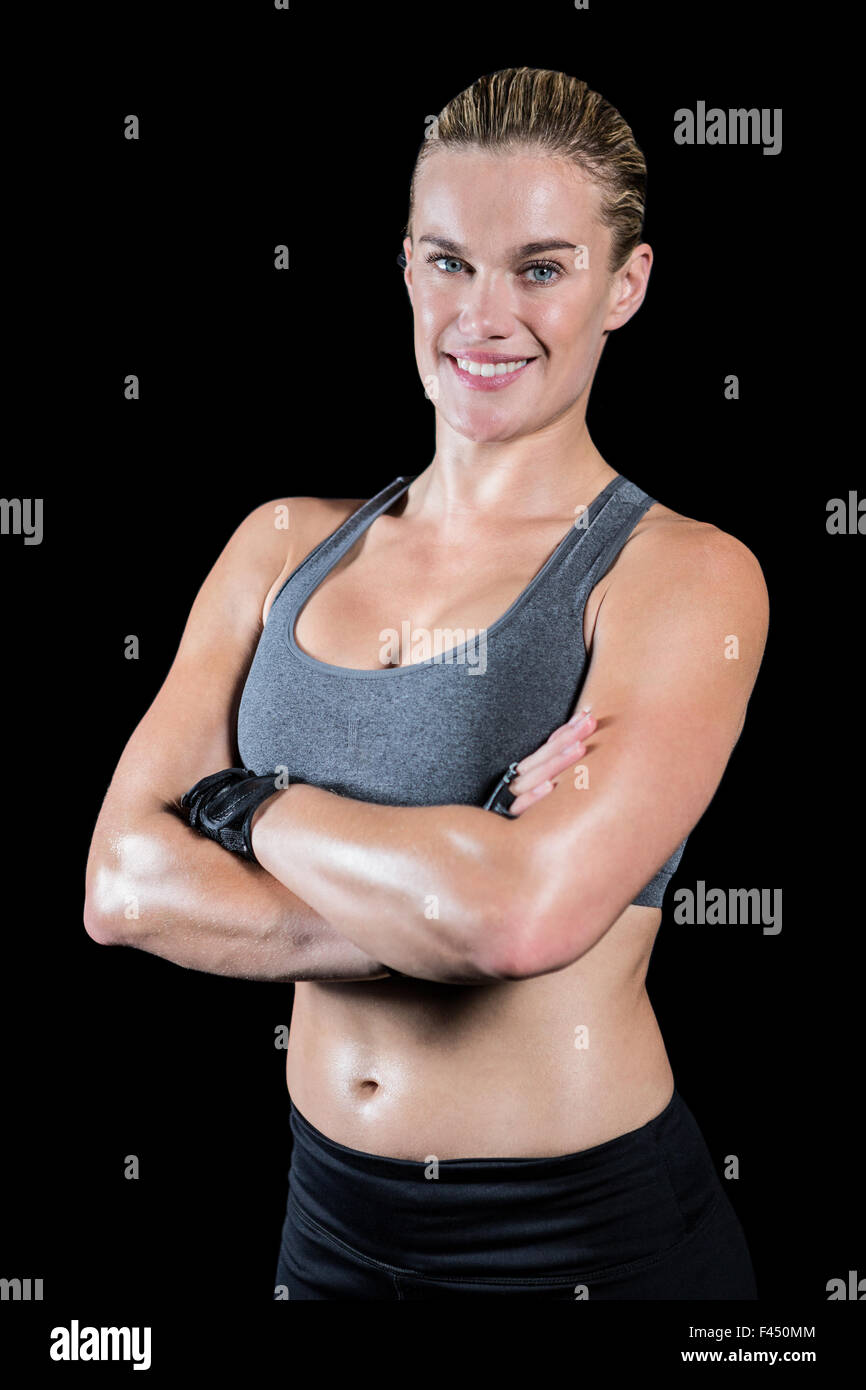 Muscular woman with arms crossed Stock Photo - Alamy