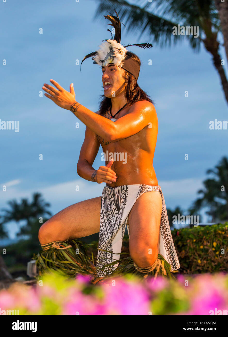 Native male Hawaiian performing traditional dance at Luau, Big Island, Hawai'i, USA Stock Photo
