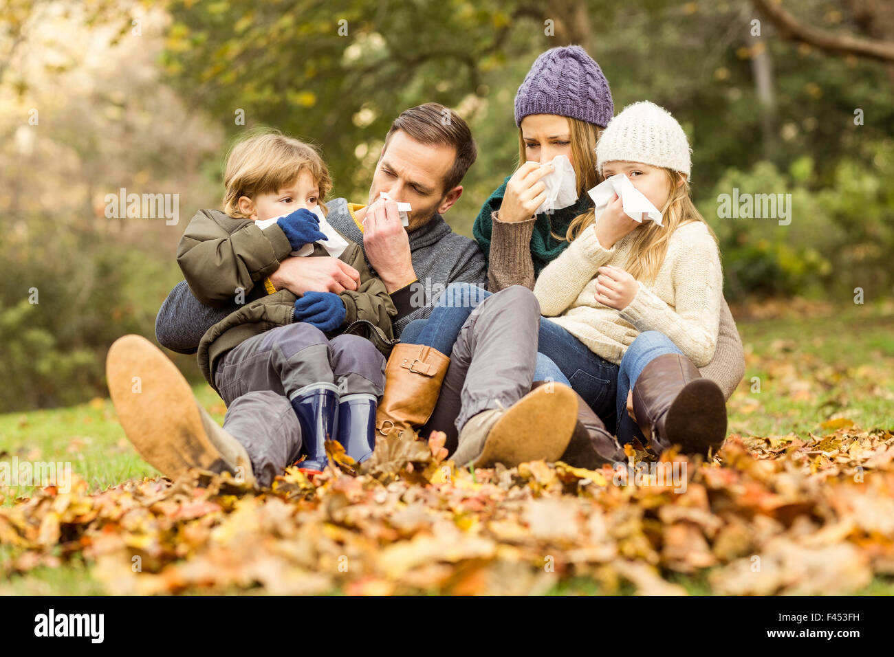 Young family blowing their nose Stock Photo