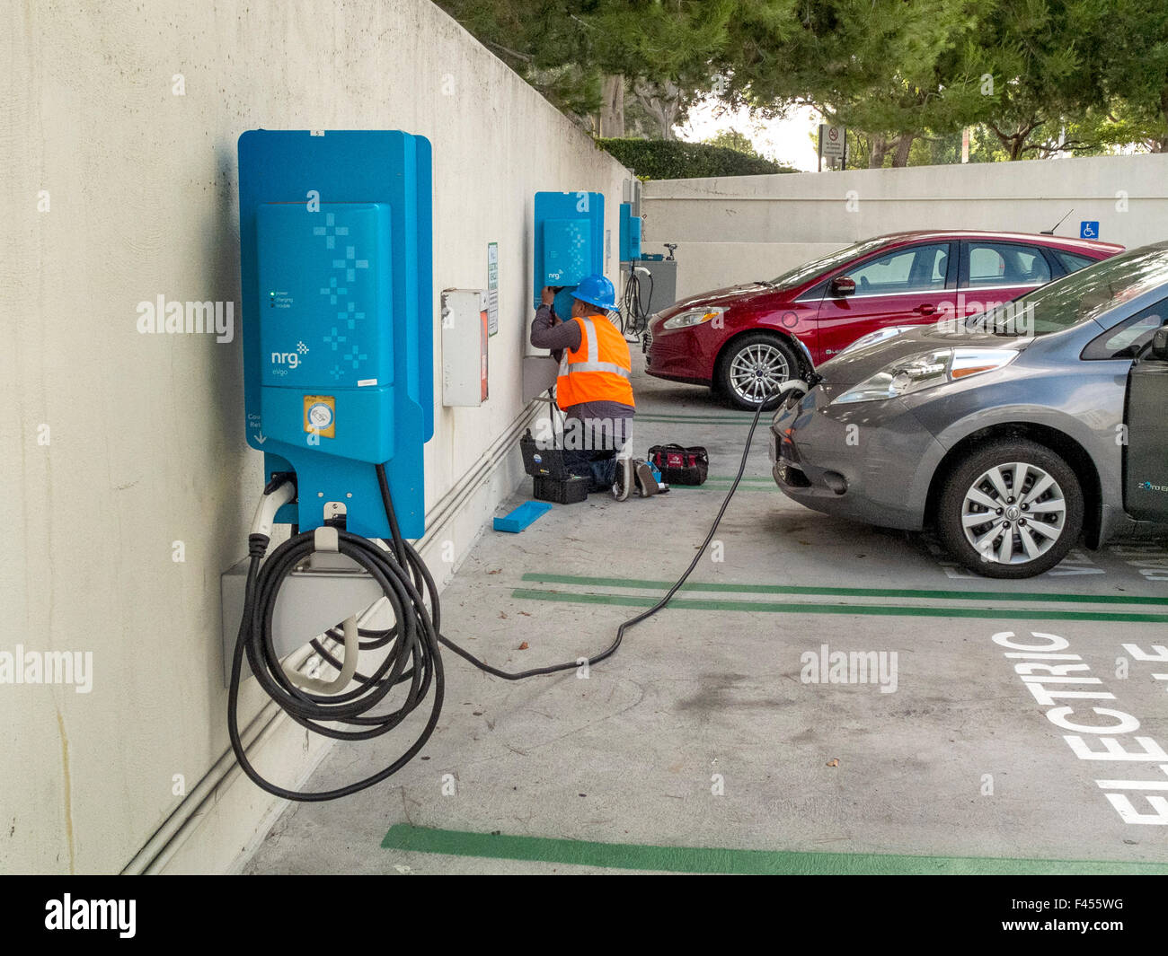 Repair technician maintaina an electric car charging station at an