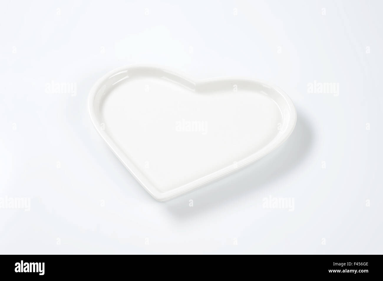white heart shaped plate on white background Stock Photo - Alamy