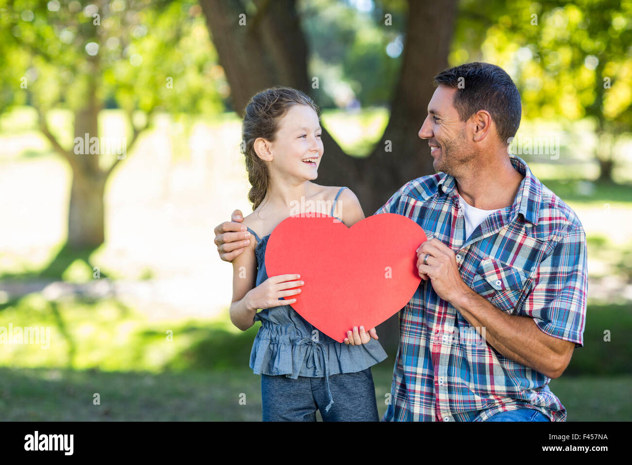 Father and daughter smiling in the park Stock Photo - Alamy