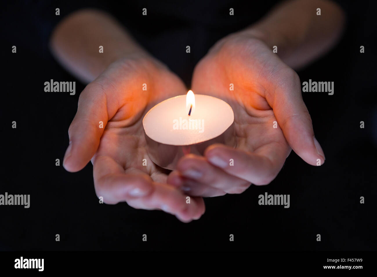 Hands holding candle Stock Photo Alamy