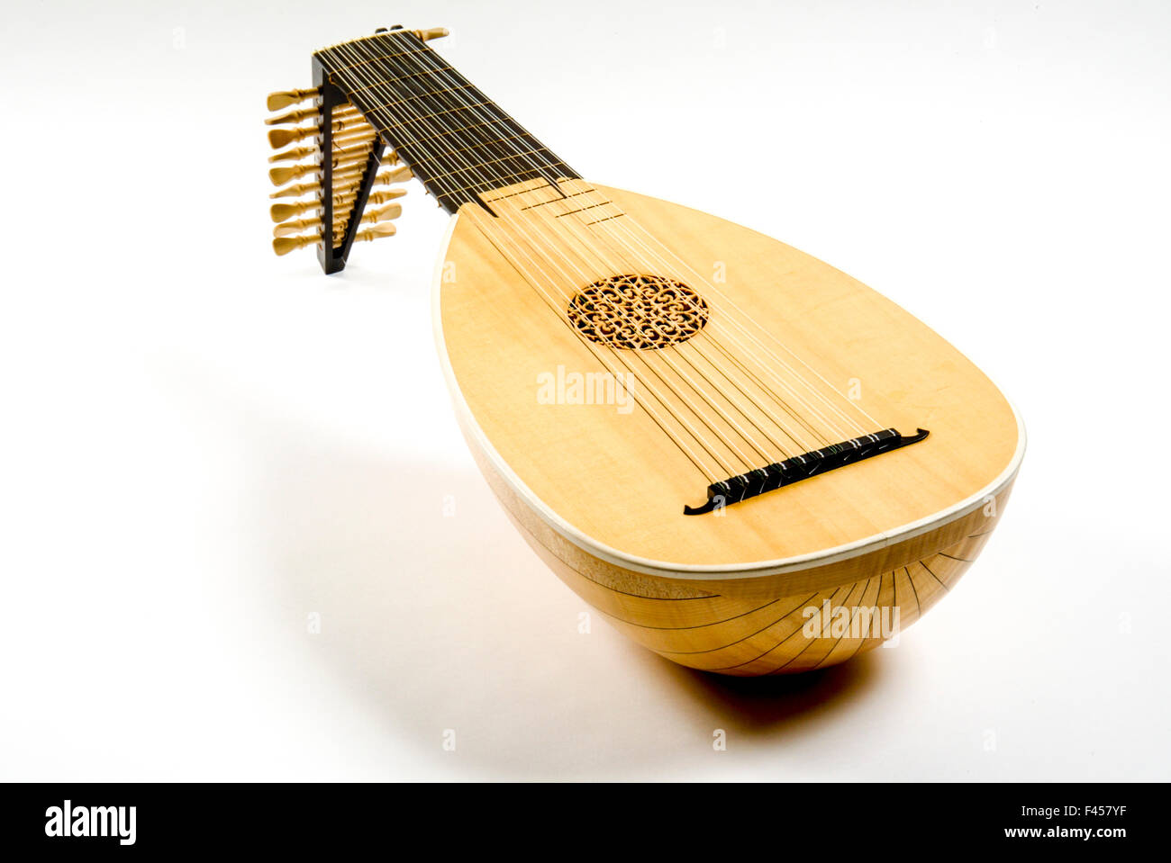 A lute is a plucked string instrument with a neck (either fretted or unfretted) having the strings running in a plane parallel to the sound table and a deep round back. Stock Photo