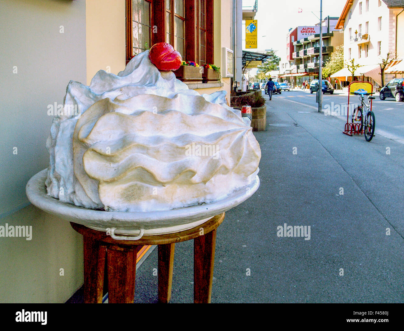 A huge model of a meringue beckons customers to a restaurant in Meiringen, Switzerland. The dessert, made with egg whites and sugar, is a signature dish in the city. Stock Photo