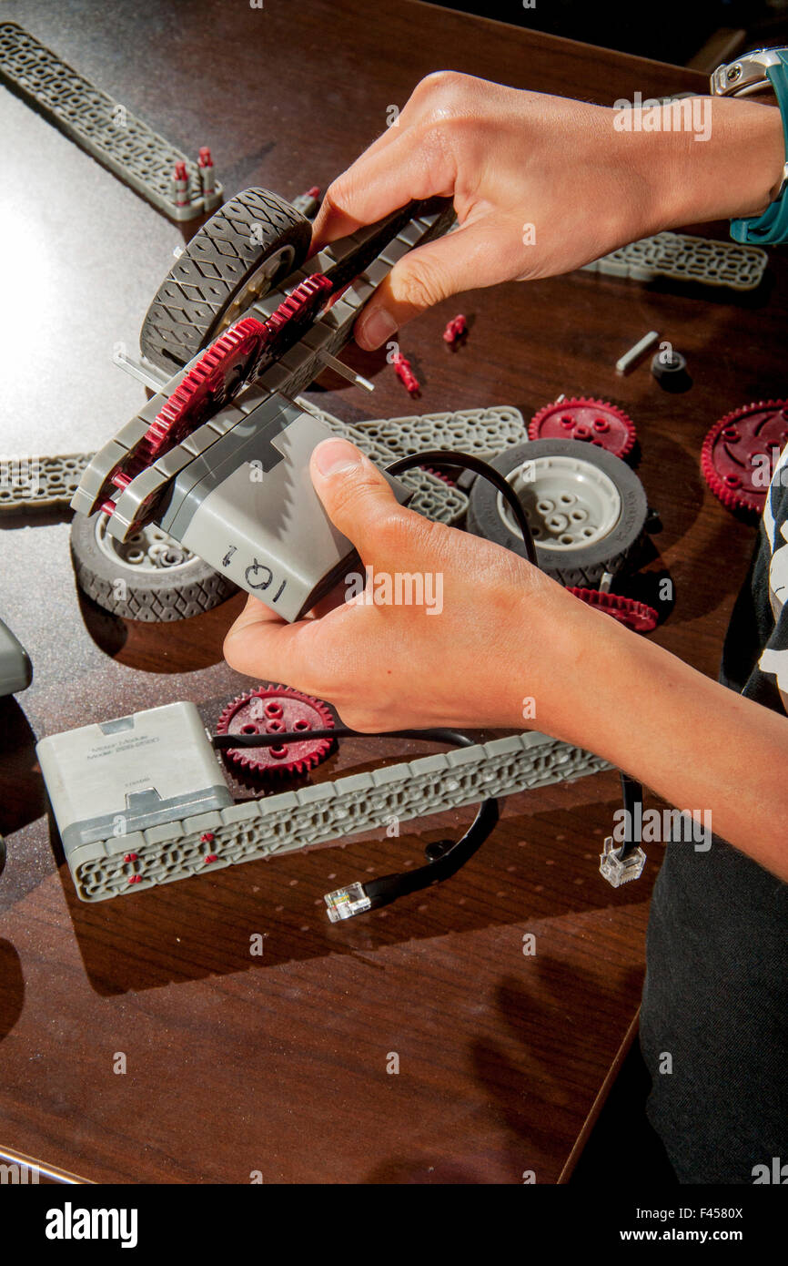 A teen technologist adds snap on spare parts to a modular VEX Robot
