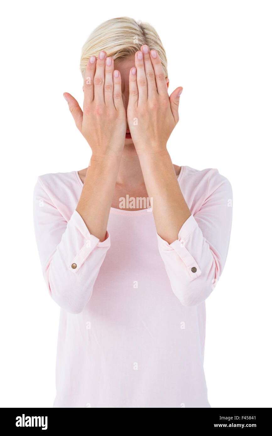 Blonde woman covering her face Stock Photo - Alamy