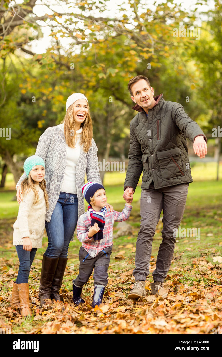 Smiling young family walking in leaves Stock Photo