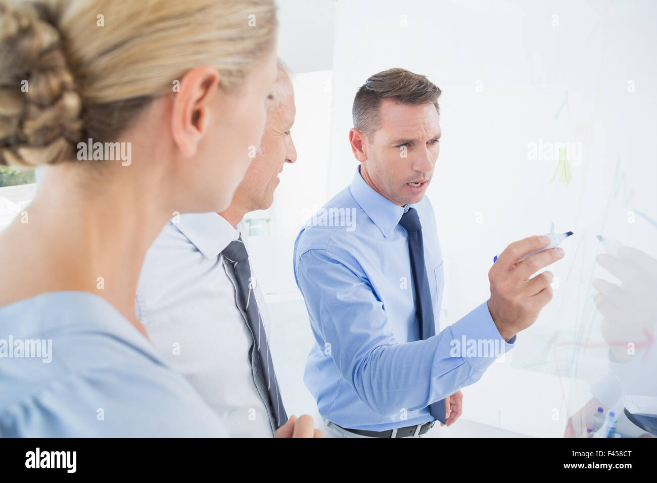 Businessman explaining graph on whiteboard hi-res stock photography and ...