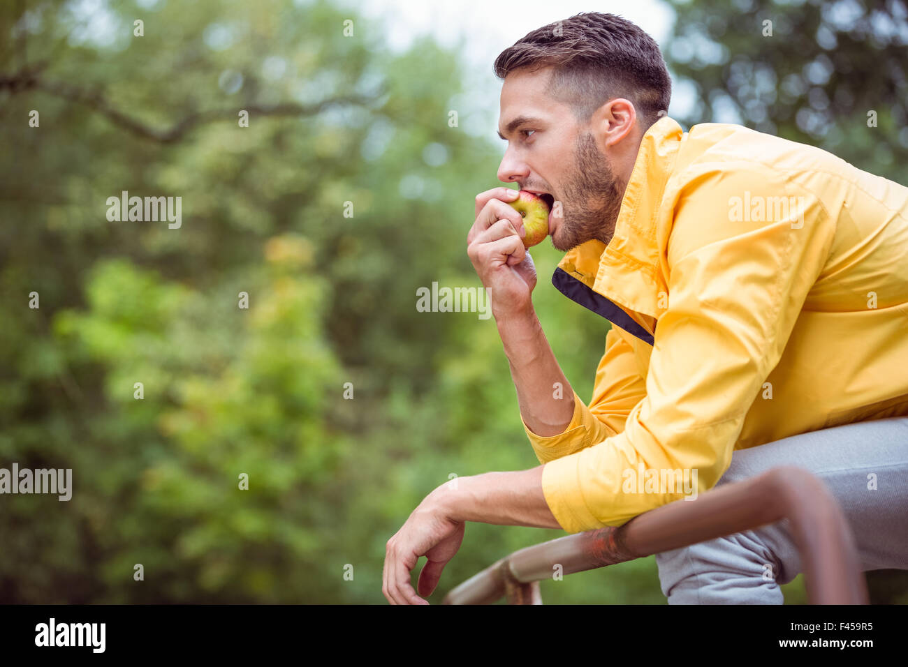 Fit man eating an apple Stock Photo