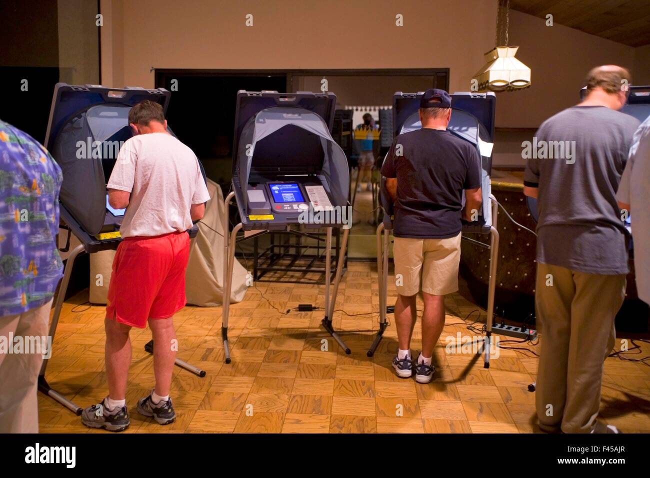 Residents of a Laguna Niguel, CA, condominium community vote at the polls at their clubhouse on Election Day evening. Note computer voting machines. Stock Photo