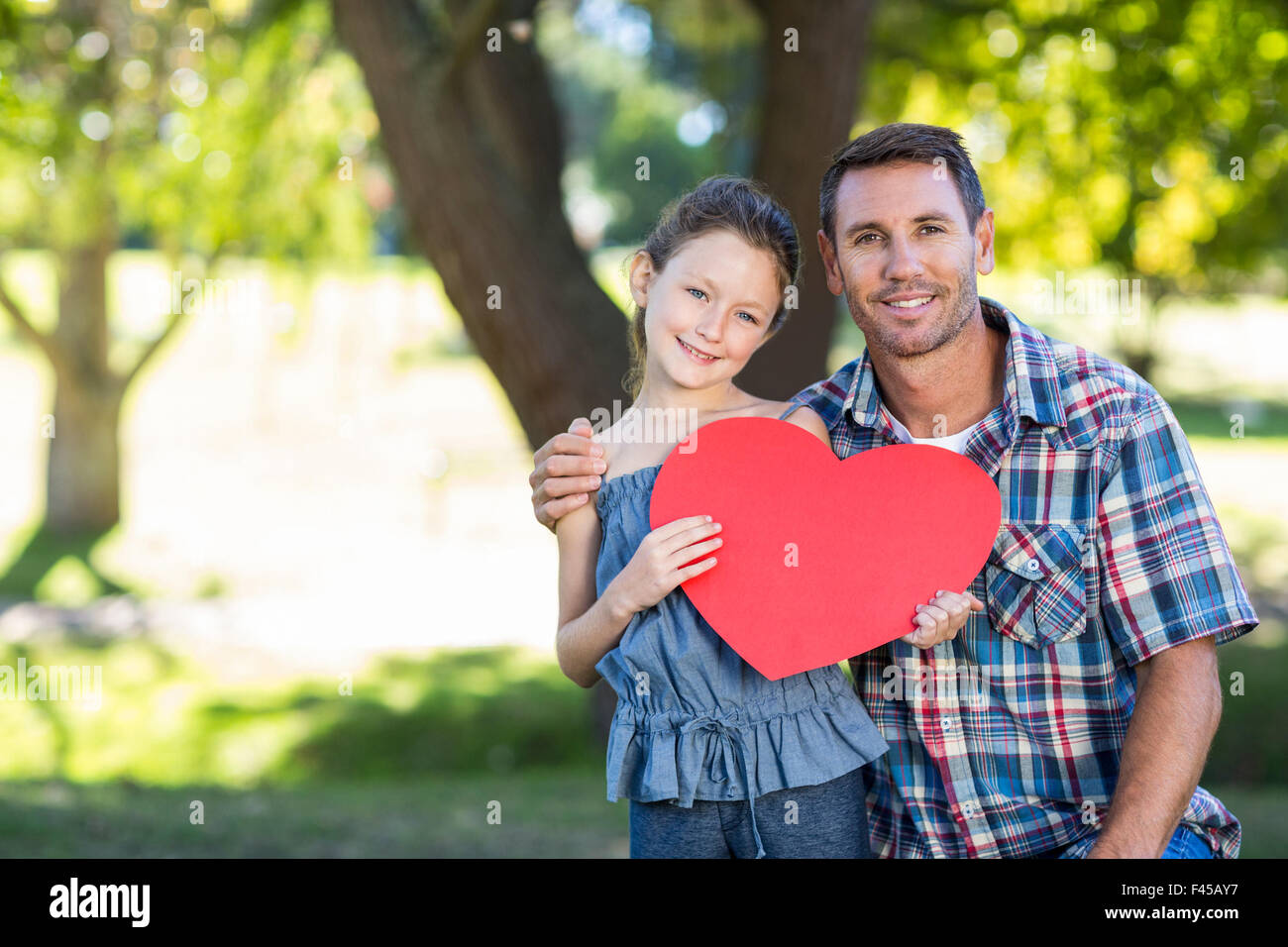 Father and daughter smiling in the park Stock Photo - Alamy