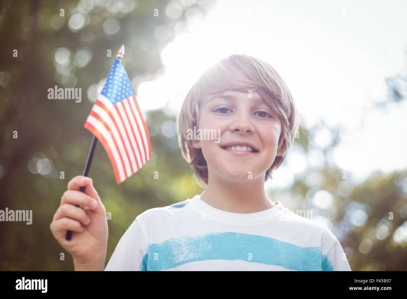 Young boy holding an american flag Stock Photo - Alamy