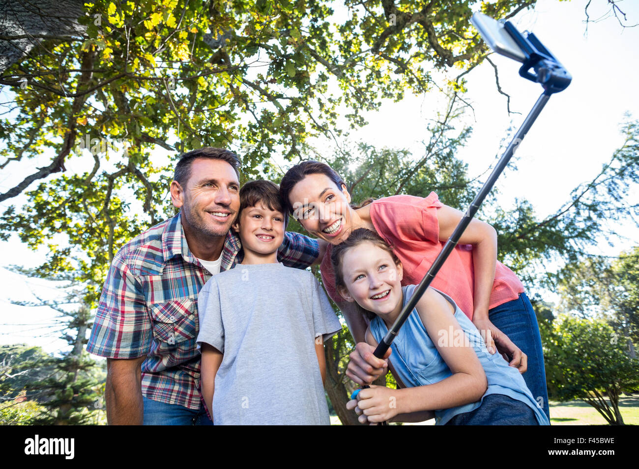 Happy family in the park taking selfie Stock Photo - Alamy