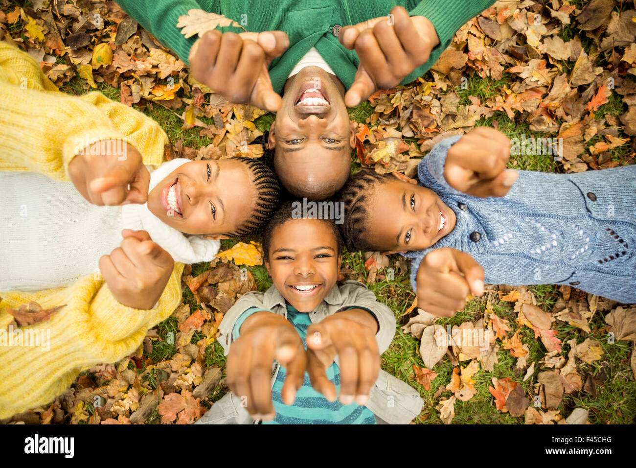 Young family doing a head circles and pointing the camera Stock Photo