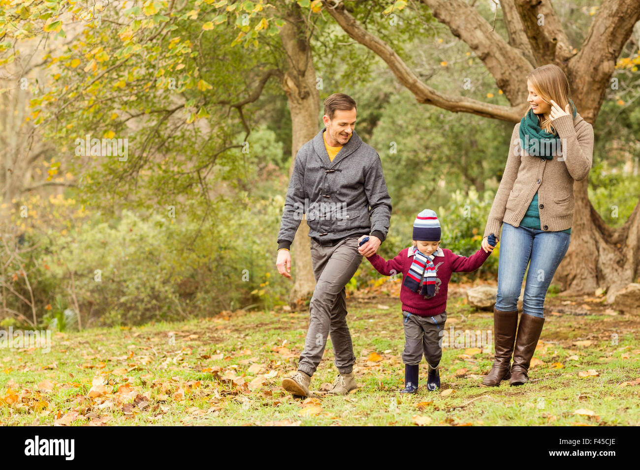 Smiling young family walking together Stock Photo