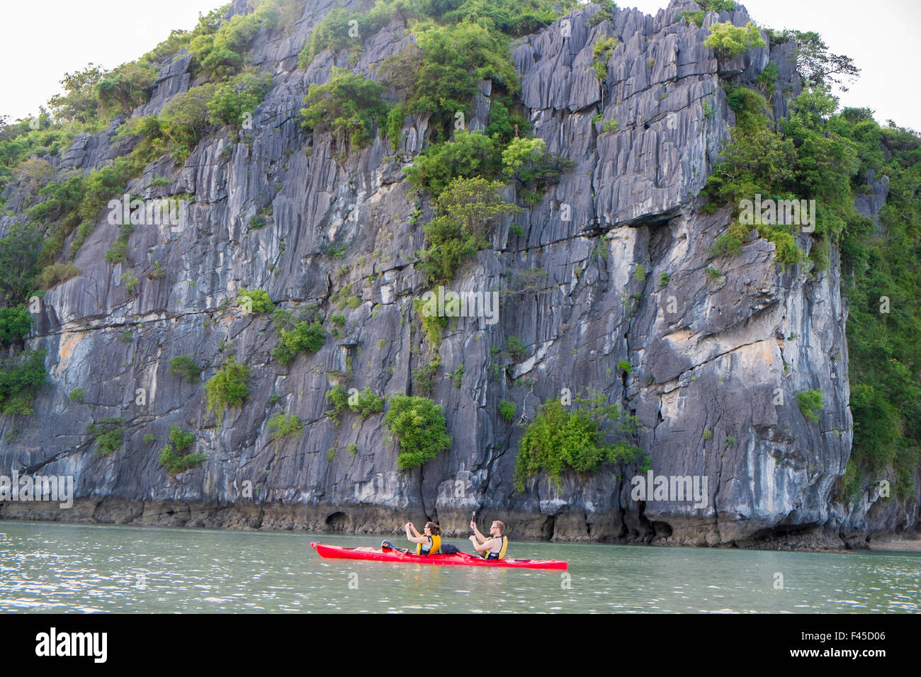 Two people in a kayak near Cang Do island in Bai Tu long bay part of Halong Bay,Vietnam,Asia Stock Photo