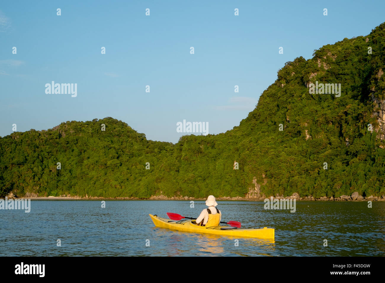 Man in a kayak on the waters around Cang Do island,Bai Tu long bay in Haong bay,Vietnam,Asia Stock Photo