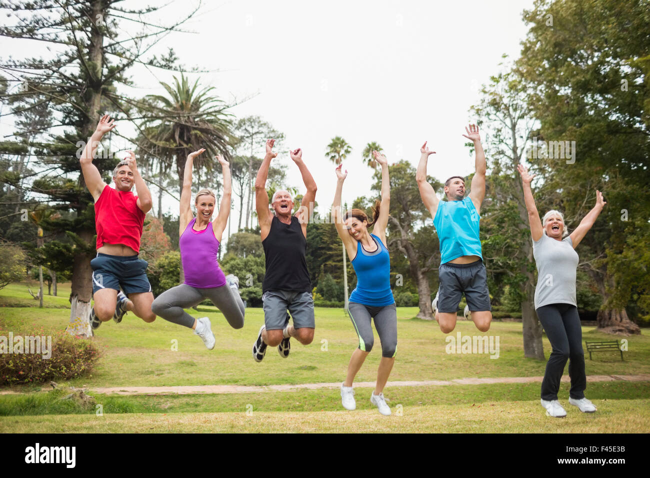 Happy athletic jumping together Stock Photo - Alamy