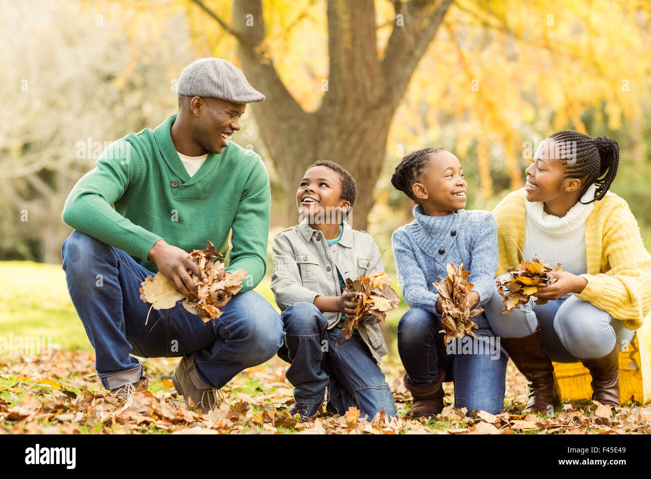 Portrait of young family holding leaves Stock Photo