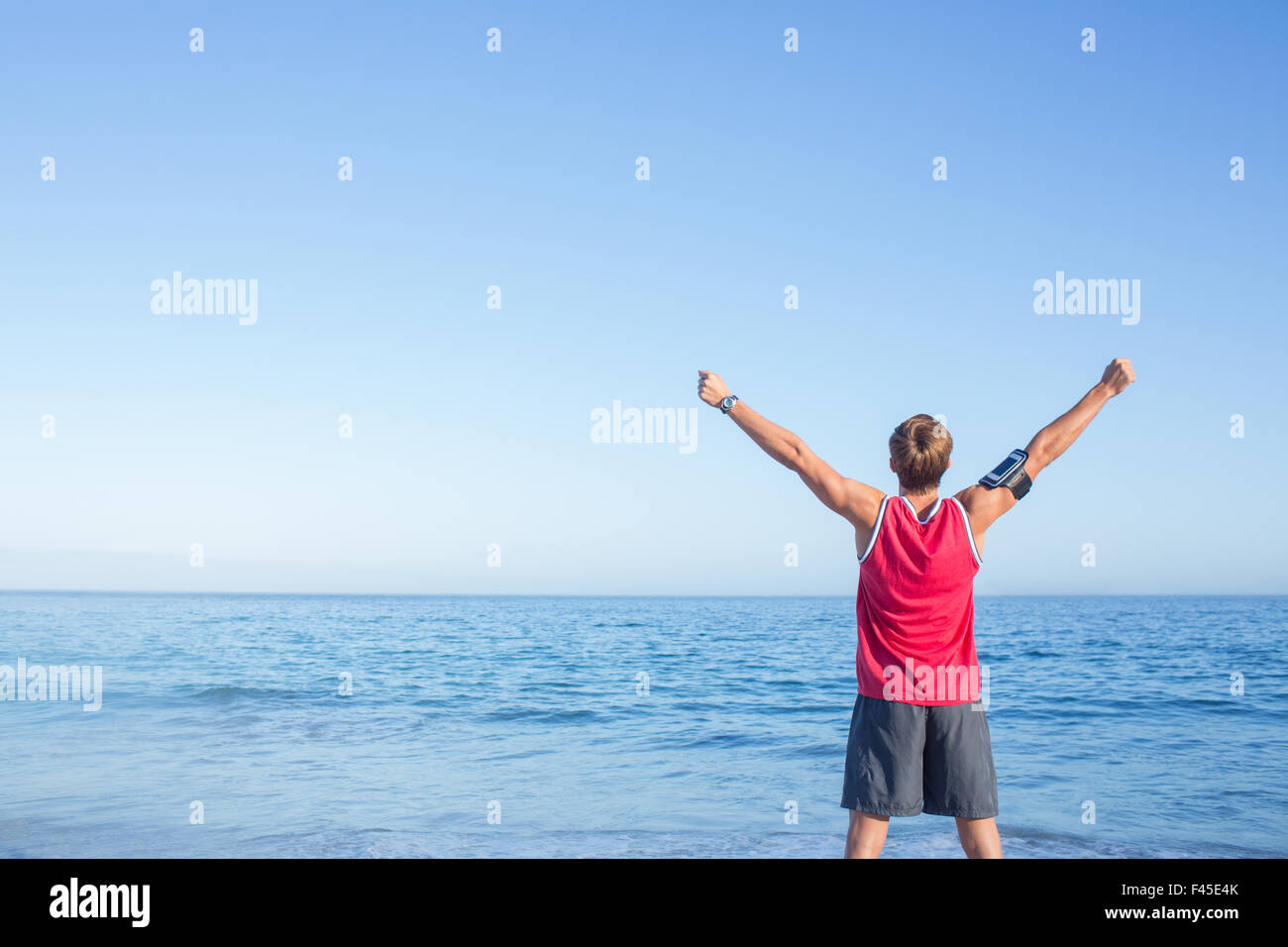 Handsome man raising arms Stock Photo - Alamy