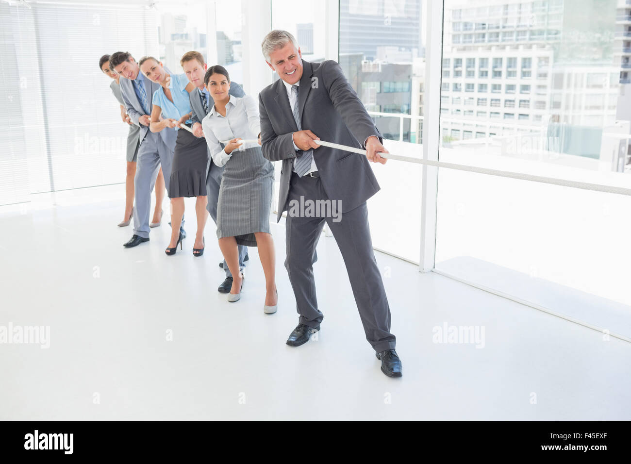 Team Members Pulling Rope Business team pulling the rope Stock Photo - Alamy