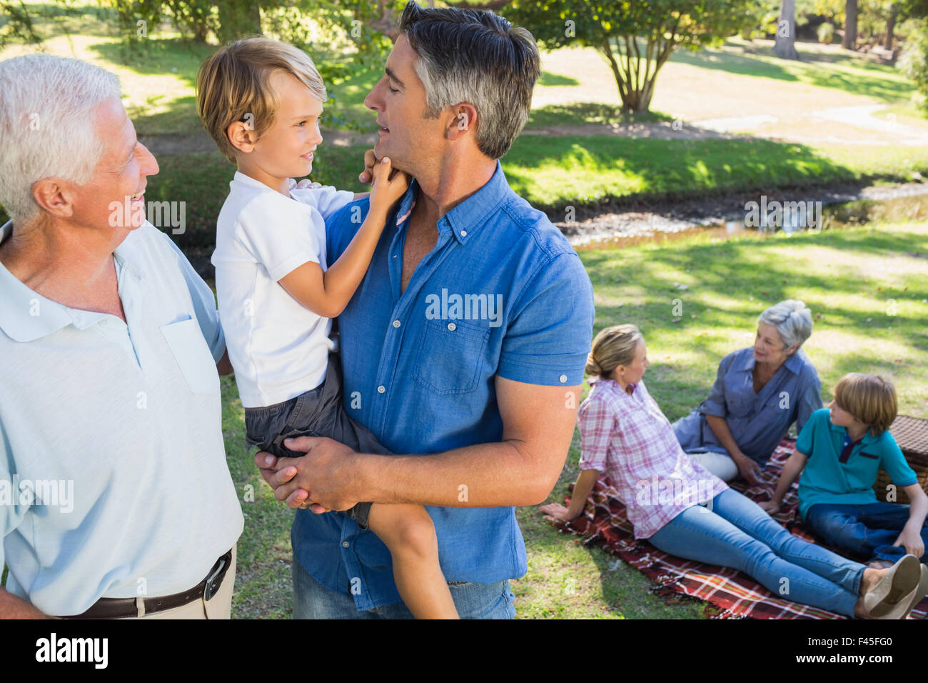 Happy family in the park Stock Photo - Alamy
