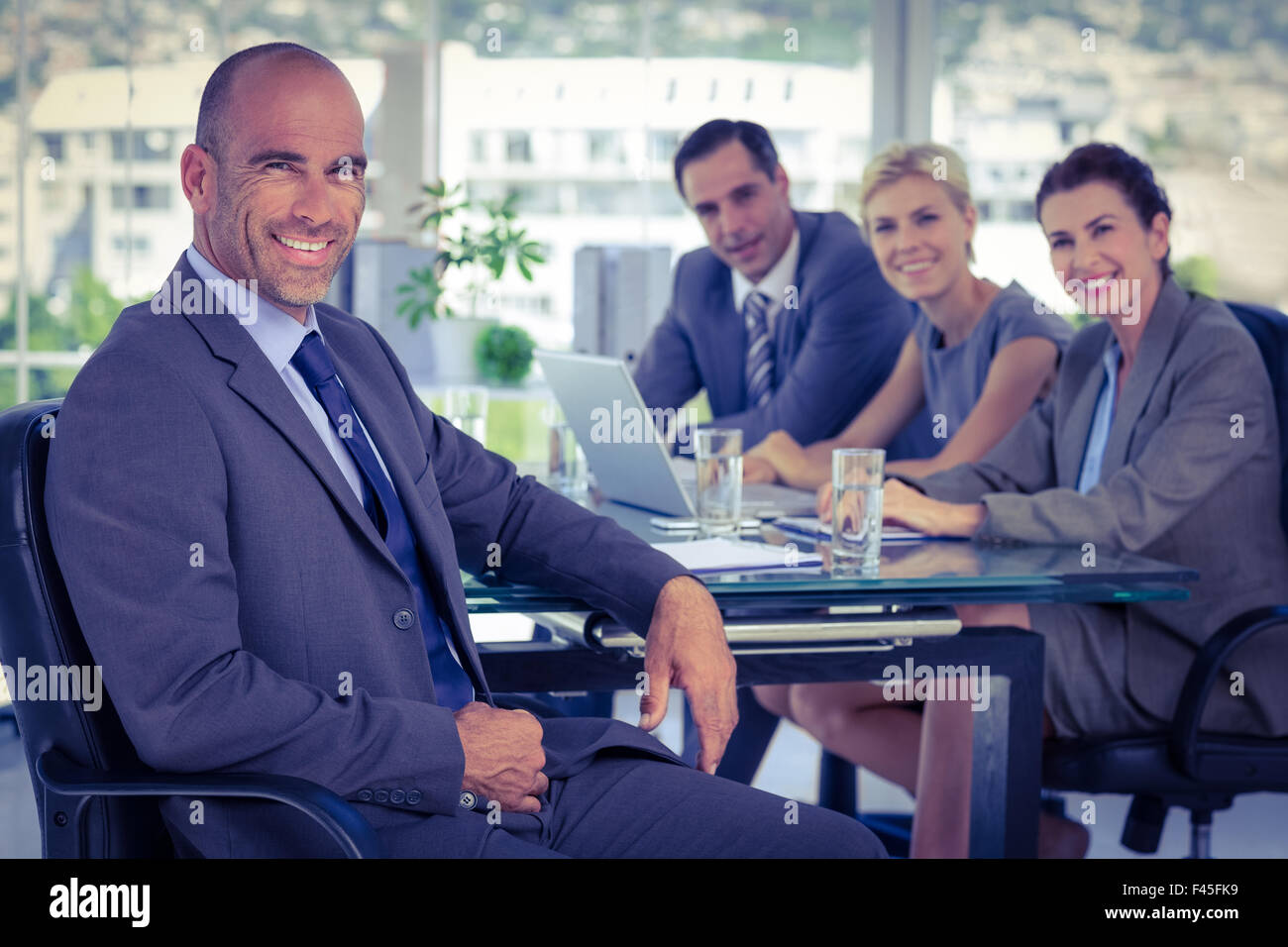 Business team smiling at the camera Stock Photo - Alamy
