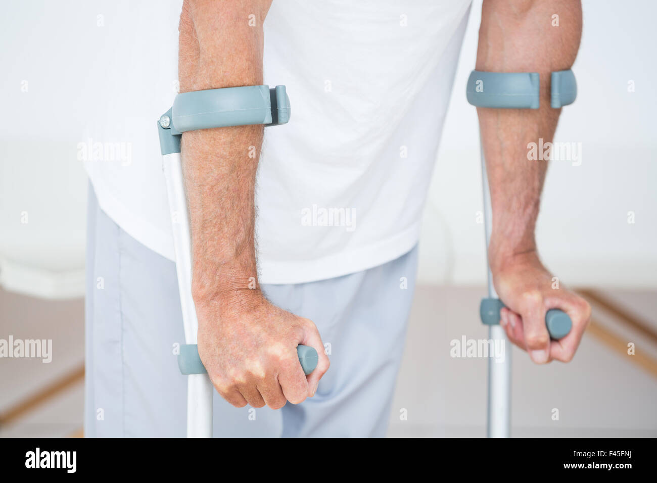 Patient standing with crutch Stock Photo Alamy