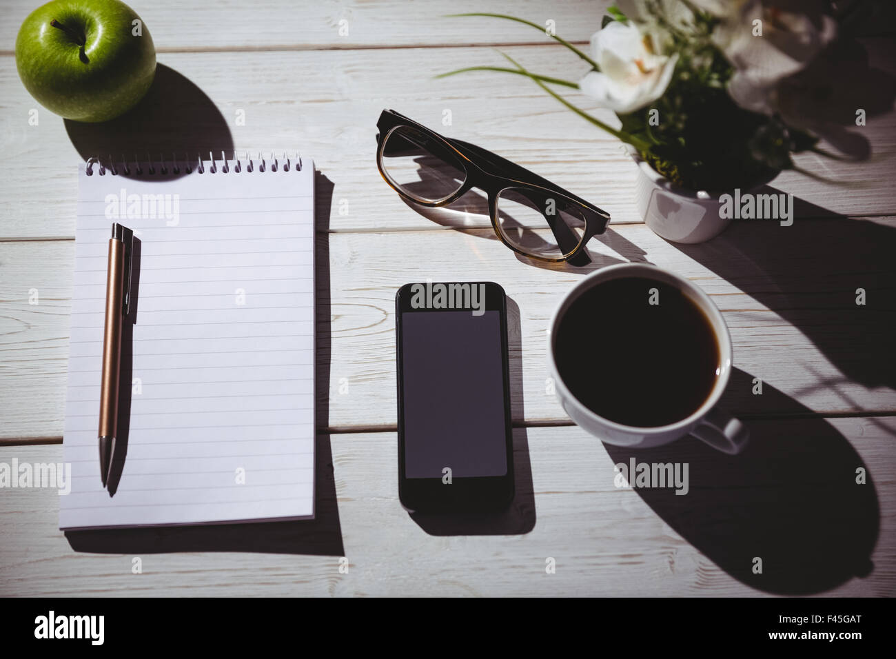 Overhead shot of notepad and smartphone Stock Photo - Alamy