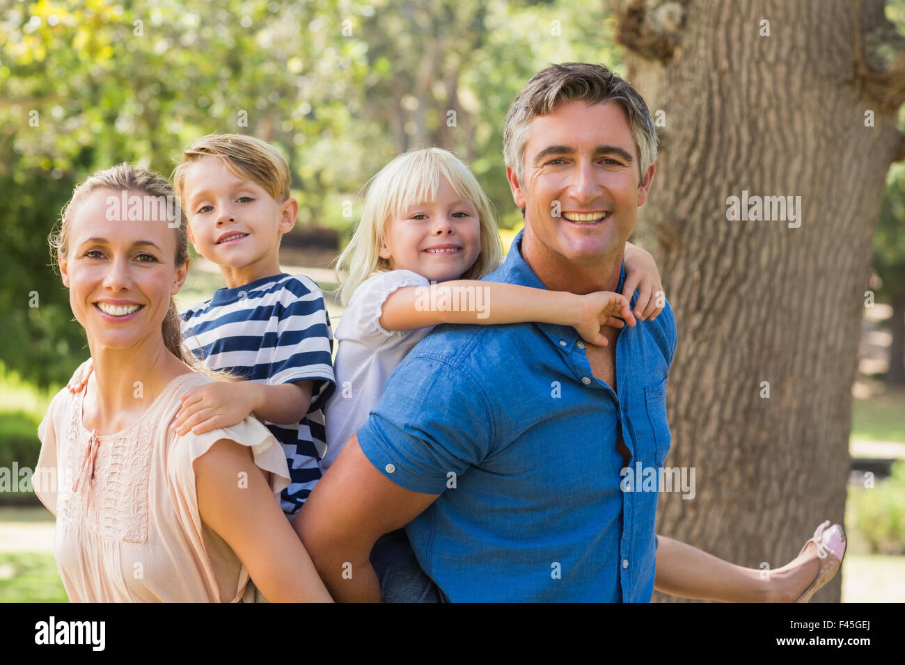 Happy family playing in the park together Stock Photo - Alamy