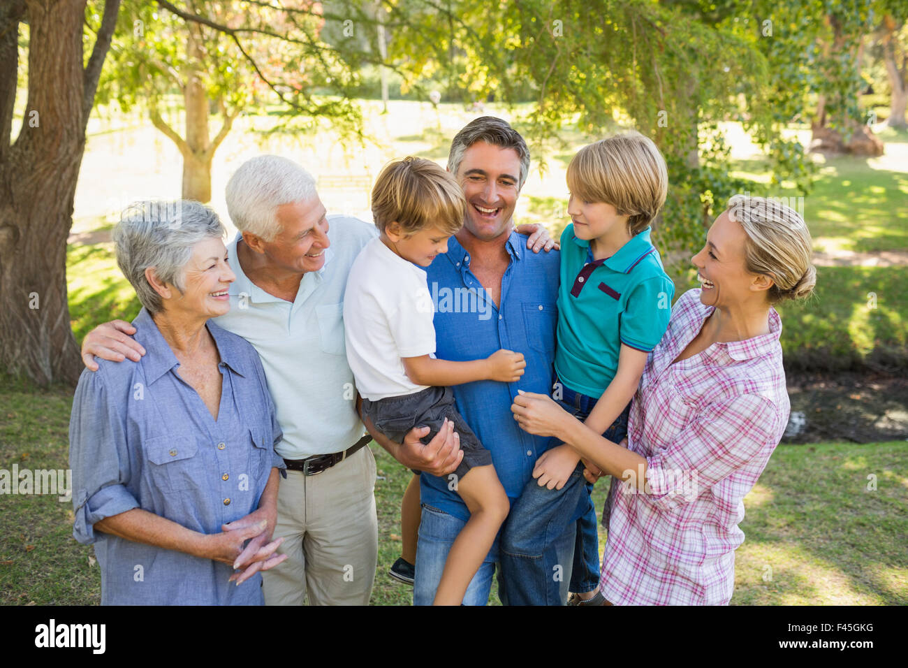 Happy family in the park Stock Photo - Alamy