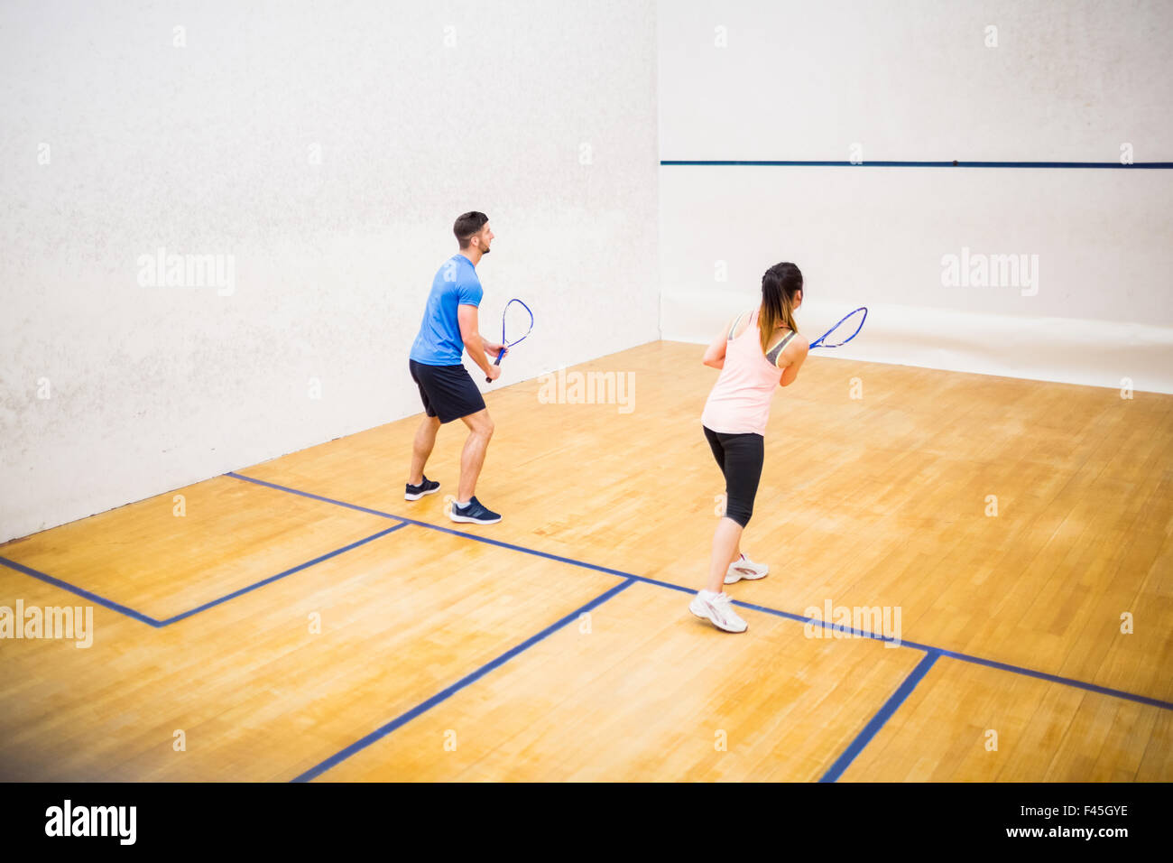 Couple playing a game of squash Stock Photo