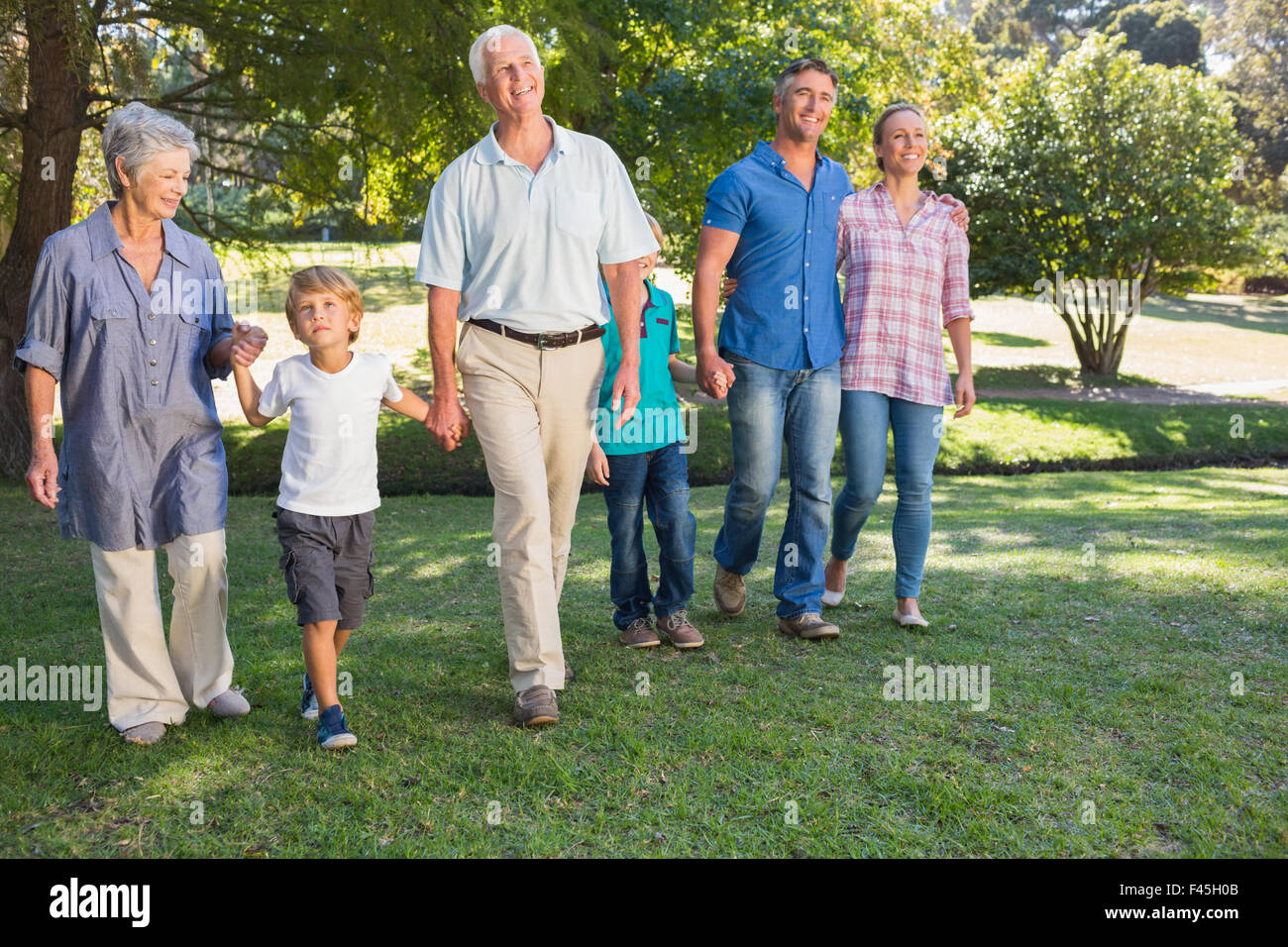 Happy family walking in the park Stock Photo - Alamy